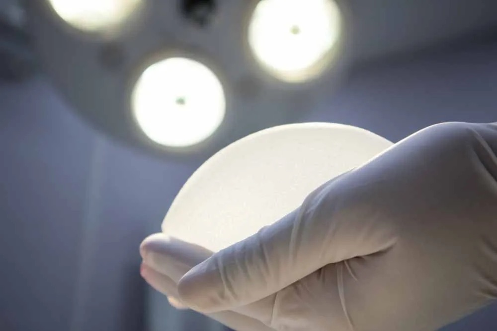 Doctor holding breast implant