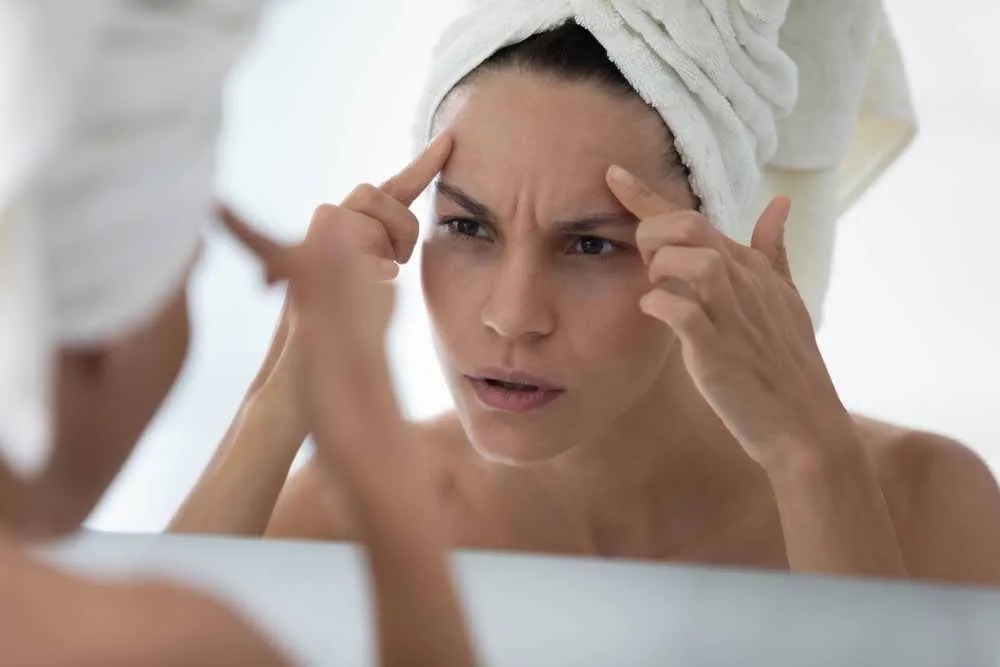 Woman looking at forehead